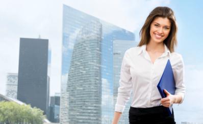 Business woman walking outside office with a folder3